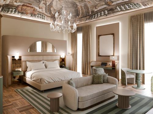 a bedroom with a bed and a couch and a chandelier at Rosetta Hotel Perugia Tapestry Collection By Hilton in Perugia