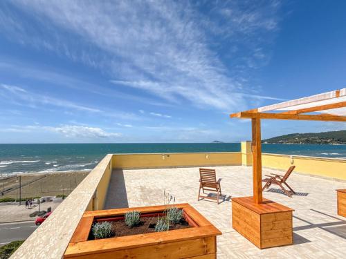 a patio with a view of the ocean at Il Mare In Giardino in Scauri