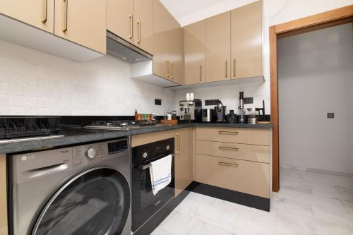 a kitchen with a washing machine in a kitchen at Otto By Atlantis in Agadir