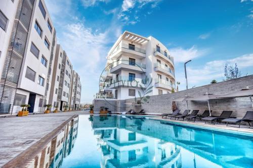 a hotel swimming pool in front of a building at Otto By Atlantis in Agadir