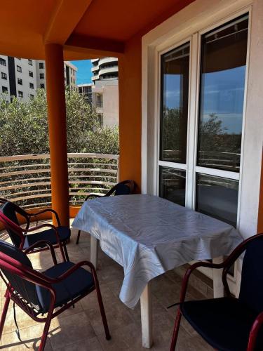 a porch with a table and chairs on a balcony at Better place in Becici