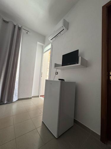 a white refrigerator in a room with a window at Viron Apartament in Himare