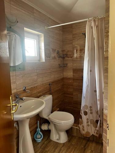 a bathroom with a toilet and a sink at Better place in Becici