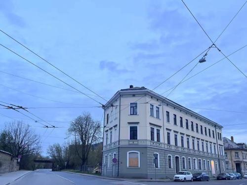 a white building sitting on the side of a street at Warm & Cozy apartment at Akmenu iela in Rīga