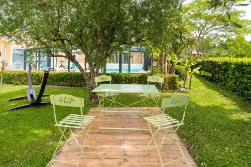 a table and chairs sitting on a brick path in the grass at Villa d exception 3 étoiles in Clermont