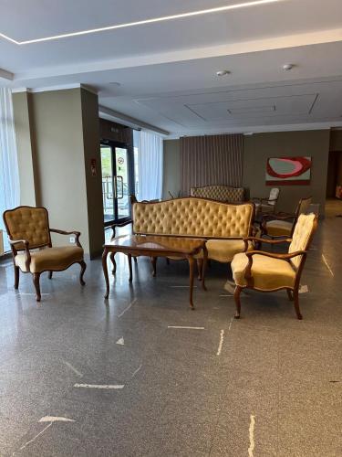 a room with chairs and a couch and a table at Hotel Vento in Ventspils
