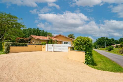 a house with a white fence and a driveway at Villa d exception 3 étoiles in Clermont