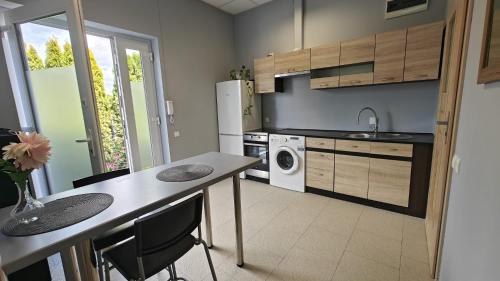 une cuisine avec une table et une machine à laver dans l'établissement Apartament, Mieszkanie, à Poznań