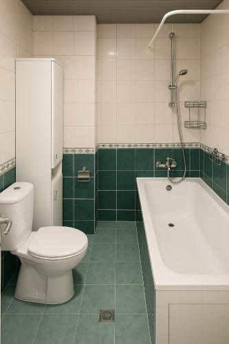 a bathroom with a toilet and a tub and a sink at Casa Verde LLS in Budva
