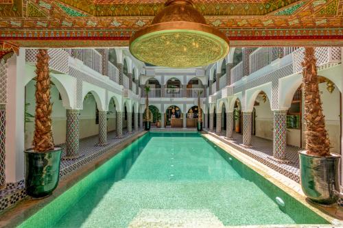 a swimming pool in a building with a ceiling at Palais Moulay Said & SPA in Marrakech