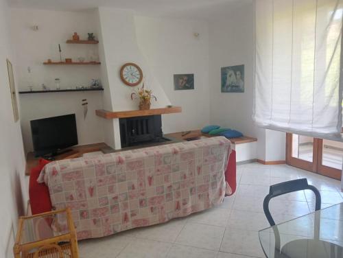 a living room with a couch and a tv at ai Confini in Castelnuovo di Val di Cecina