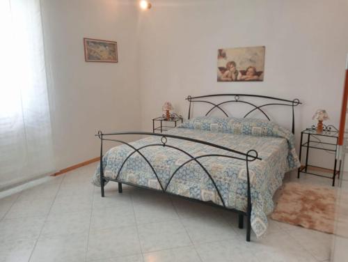 a bedroom with a bed and two night stands at ai Confini in Castelnuovo di Val di Cecina