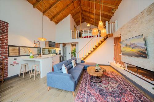 a living room with a blue couch and a table at Grand Paradise Resort Sapanca in Sapanca