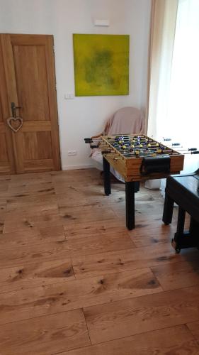 a room with a wooden table and a chessboard at Tkalcovna U Zlatého potoka in Dobřany