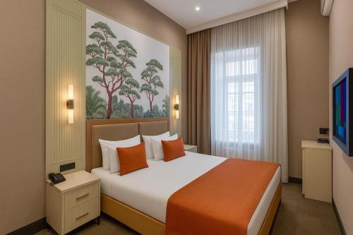 TV a/nebo společenská místnost v ubytování Nizami Central Park Hotel