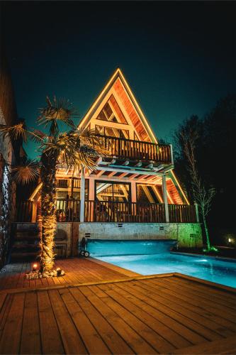 a large house with a palm tree in front of it at Grand Paradise Resort Sapanca in Sapanca