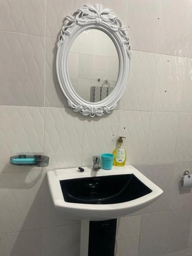 a bathroom with a white sink and a mirror at Skl apartment in Adentan
