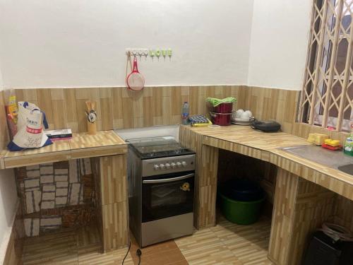 a kitchen with wooden counters and a stove at Skl apartment in Adentan
