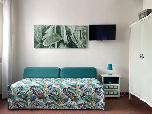a bedroom with a bed and a tv on a wall at Domus Liventa B&B in Cursi