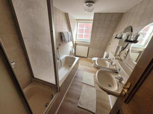 a bathroom with two sinks and a shower at Nestwerk Denkmal M38-32 - am Marktplatz, Work & Relax in Biberach an der Riß