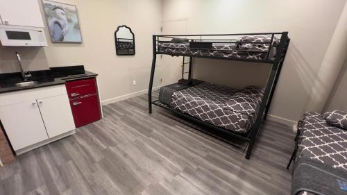 a room with two bunk beds and a kitchen at 31 Street Broadway Hotel in New York