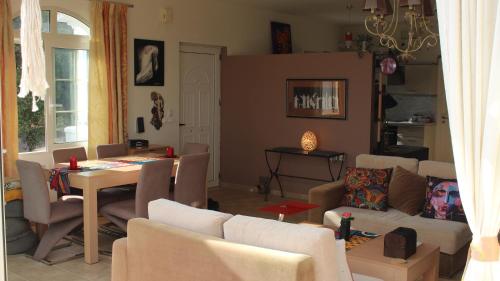 a living room with a couch and a table and chairs at Constantin in Dhémbla