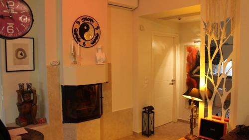 a living room with a fireplace and a clock on the wall at Constantin in Dhémbla