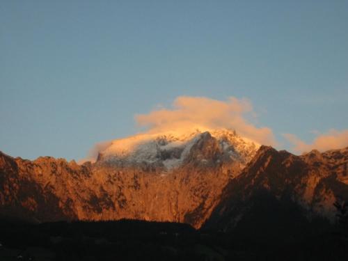 a view of a mountain with the sun shining on it at Ferienwohnung Springl in Schönau am Königssee