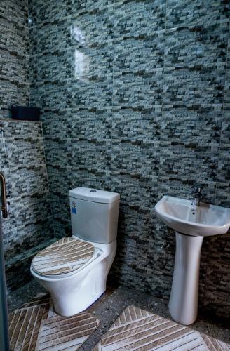 a bathroom with a toilet and a sink at Valley View KK 191 in Kigali