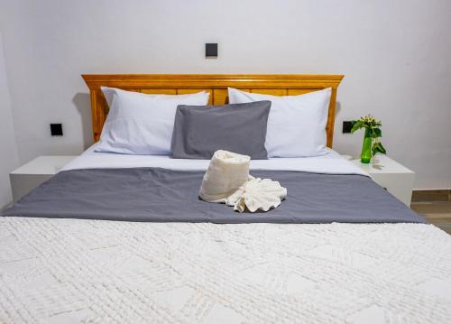 a bed with a hat on top of it at Valley View KK 191 in Kigali