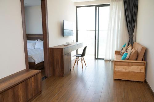 a bedroom with a bed and a desk and a mirror at Thy Hung legacy hotel in Tuy Hoa