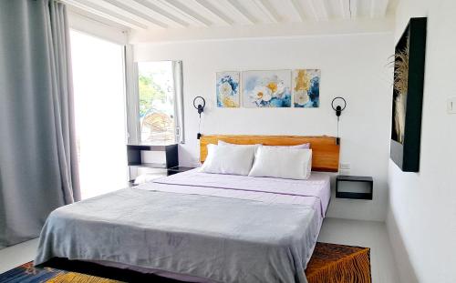Ένα ή περισσότερα κρεβάτια σε δωμάτιο στο Bougainvillea guesthouse