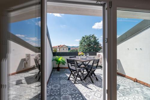 a patio with a table and chairs on a balcony at La tana dei sogni in Chieri