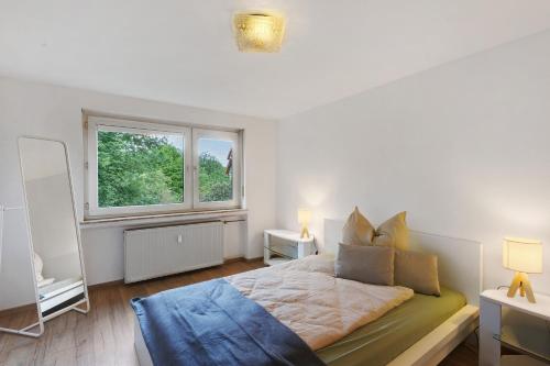 a bedroom with a large bed and a window at You R Welcome in Lauterbach