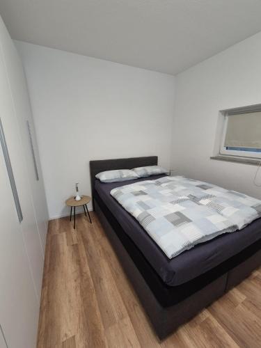 a bedroom with a bed and a wooden floor at Fewo Schlossbühl in Meersburg