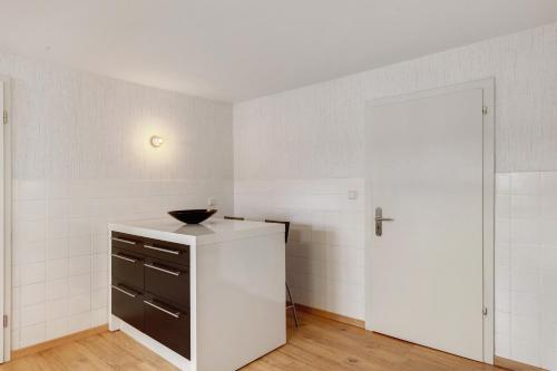 a white room with a black bowl on a counter at You R Welcome in Lauterbach