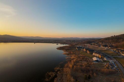 an aerial view of a lake at sunset at Lake Hill Karkonosze Resort & Spa in Sosnówka