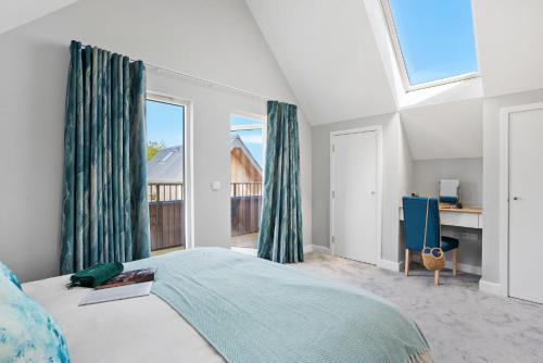 a bedroom with a bed and a large window at No 2 The Vista, Willingcott, Woolacombe in Woolacombe