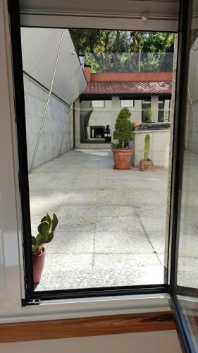 a view from a window of a courtyard with a cactus at Hotel Brisa del Mar in O Grove