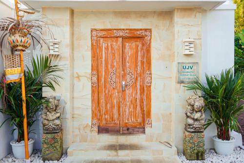 a wooden door on the side of a house at Uluwatu Jungle Villa in Uluwatu