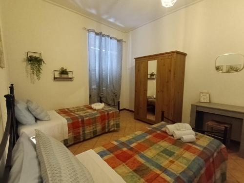 a living room with two beds and a fireplace at le lanterne in Foligno