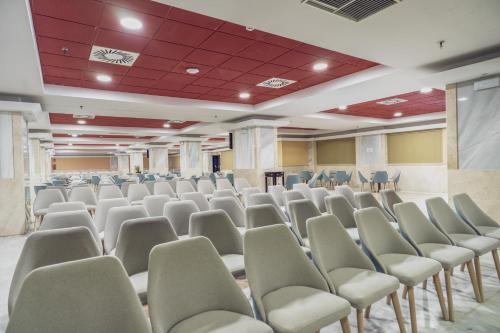 an empty room with chairs and a podium in a room at Holiday Premium Resort in Benalmádena