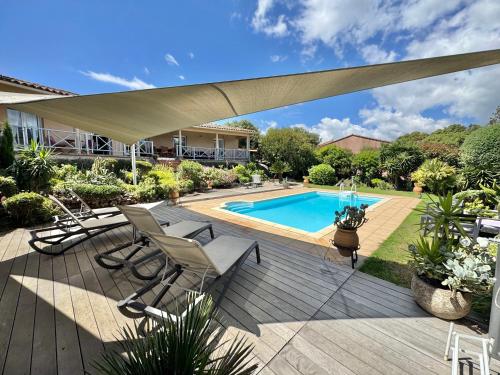 une terrasse avec des chaises et une piscine dans l'établissement Villa à Porto-Vecchio - Résidence privé, à Porto-Vecchio