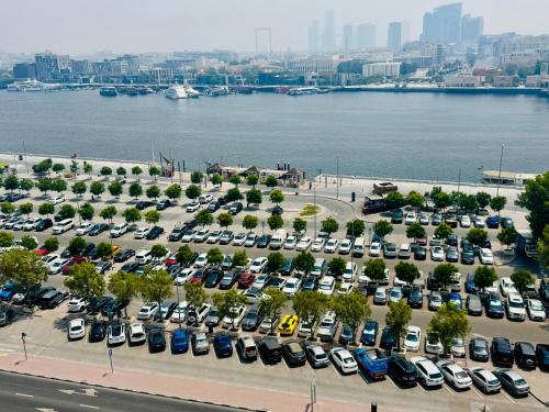 an aerial view of a parking lot with cars at Wow Amazing BurjKhalifa,Sea,Sunset,Ship,Park,Metro View,Private Home 2BHK ,Fully Furnished in Dubai