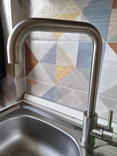 a kitchen sink with a window next to a sink at Mini appartamento vicino al lago in Dormelletto