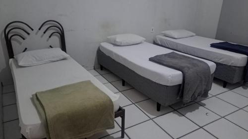 Katil atau katil-katil dalam bilik di Hotel economic eldorado Sorocaba
