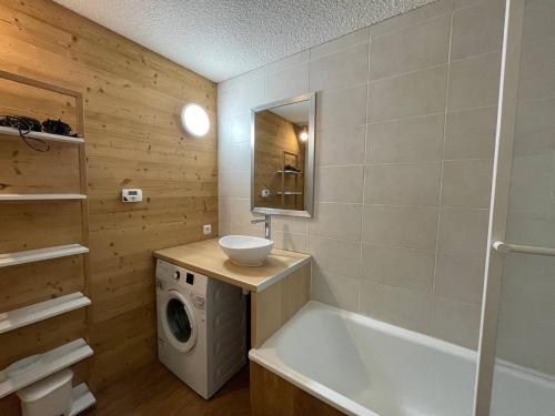 une salle de bain avec baignoire et machine à laver dans l'établissement Appart 2P skis aux pieds à Valmorel, proche pistes et commerces - FR-1-356-526, à Valmorel