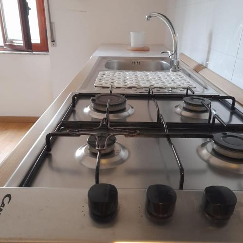 a stove top with a faucet on top of it at La Casa di Raffa in Agropoli
