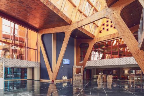 a lobby of a building with a wooden ceiling at Holiday Premium Resort in Benalmádena