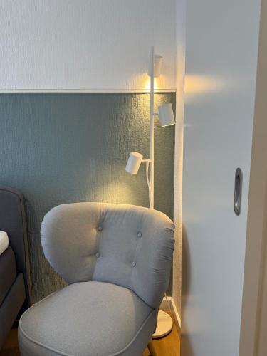 a blue chair in a room with a lamp at seemoi in Norderney